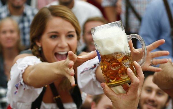 A visitor reaches for of the one of the first mugs of beer during opening ceremony for 180th Oktoberfest in Munich